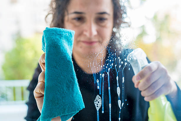 istock Woman cleaning house window 625929832