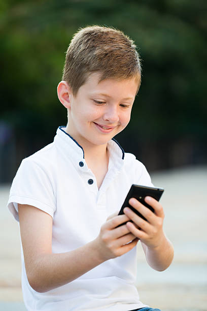 istock child playing with phone 625935306