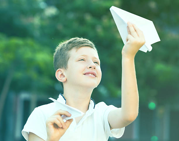 istock boy plaiing with toy airplane 625935528
