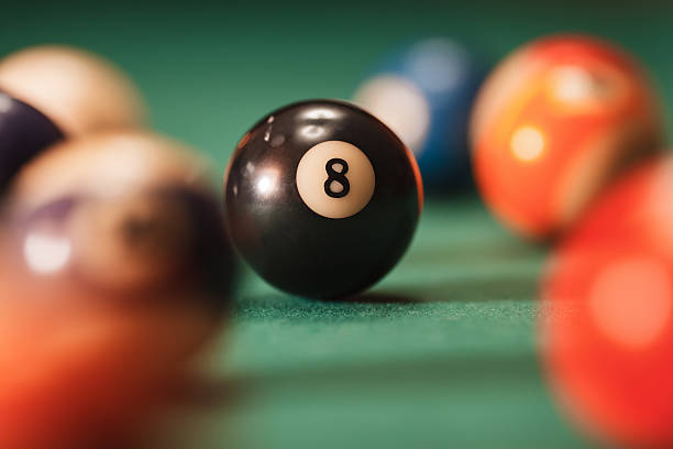 istock Pool ball with number 8 over green background. 625936232