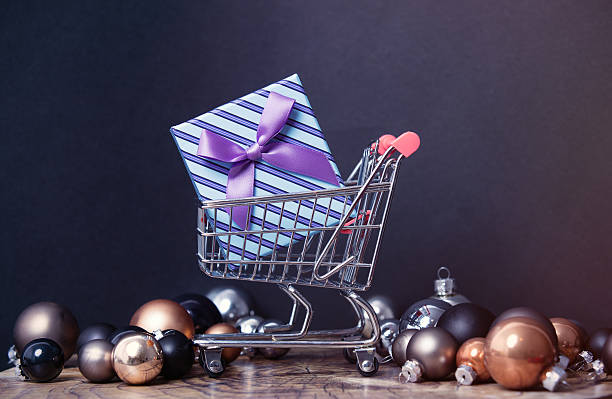 istock Gift box and cart with christmas baubles 625936260