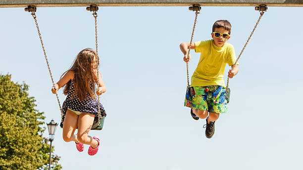 istock Two children having fun on swingset. 625936268