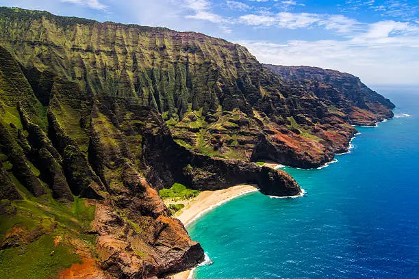 Aerial landscape view of Honopu Arch at Na Pali coastline, Kauai, Hawaii, USA