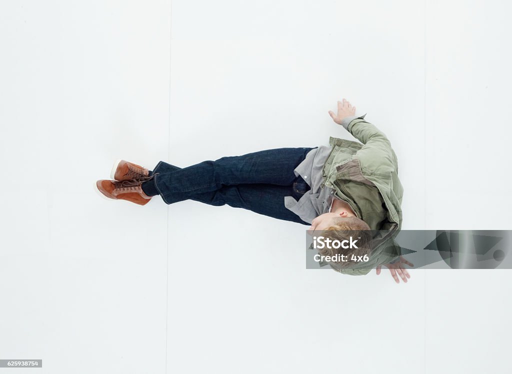 Above view of man sitting on floor High Angle View Stock Photo