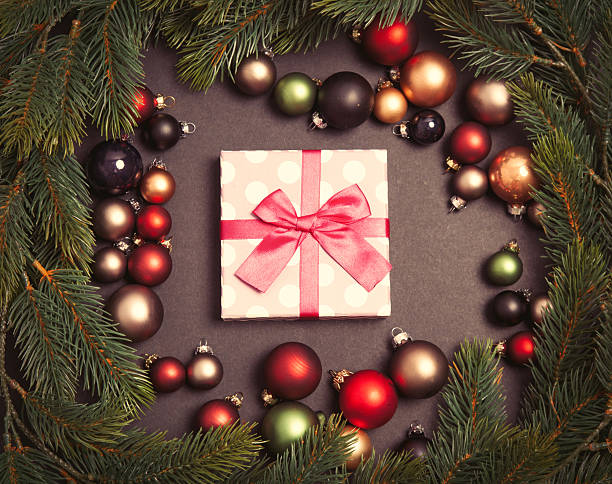 istock Christmas gift and baubles with pine branch 625942428