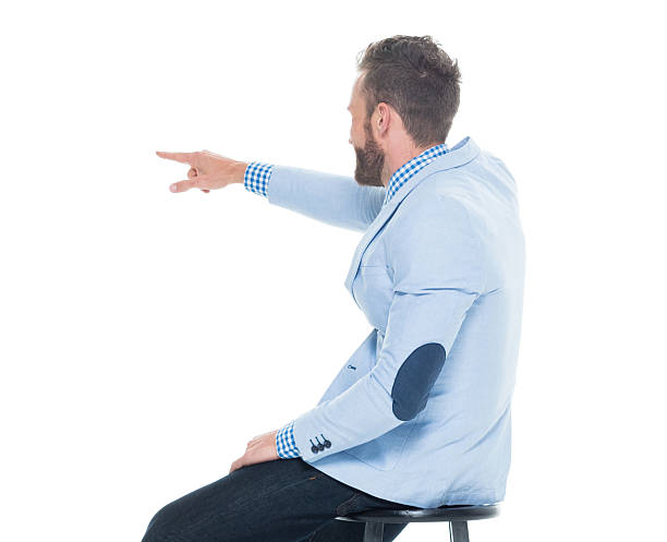 istock Rear view of smart casual man sitting and pointing 625943386