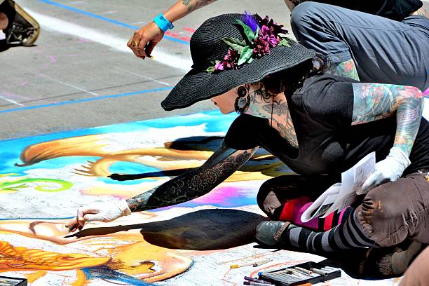 Denver, CO, USA - June 4, 2016: 2016 Denver Chalk Art Festival on Larimer Square is a two-day street-painting festival where more than 200 artists spend hours turning the streets of Larimer Square into a museum of chalk art. Unidentified artists drawing on the sidewalk with chalk. 