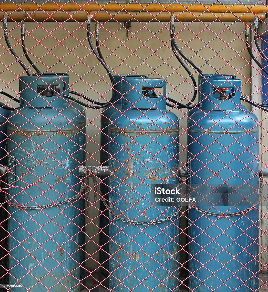 Industrial gas bottles for cooking Industrial gas bottles for cooking and heating on the proper safety place Bottle Stock Photo