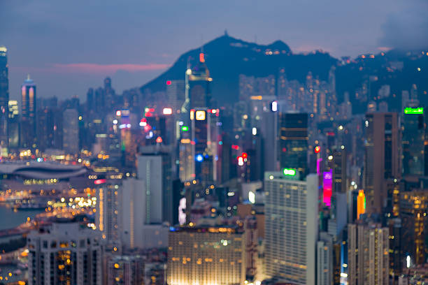 Blurred lights Hong Kong city downtown with mountain background