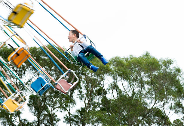 Little boy on a swinging ride