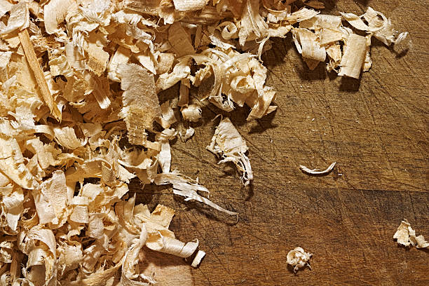 istock Wood chips on the rough wooden background 625947618