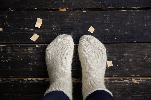 legs in warm knitted sockes stock photo