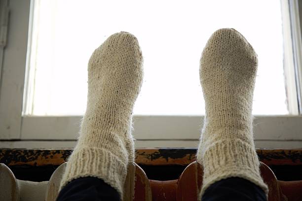 istock legs in warm knitted sockes 625948074