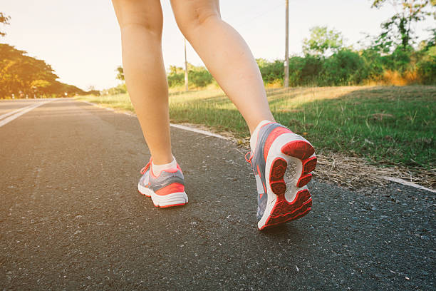 istock Young lady running on road closeup on shoes. 625948600