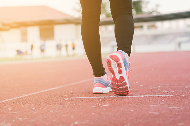 istock Young lady running on road closeup on shoes. 625948604