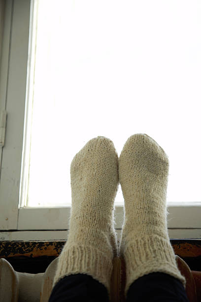 istock legs in warm knitted sockes 625953360