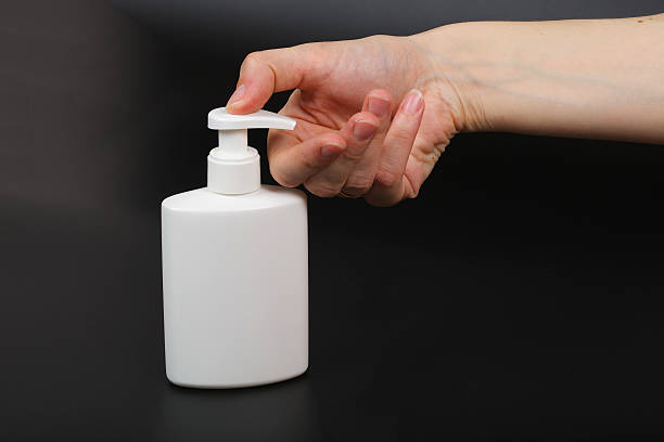 istock Liquid soap dispenser and a human hand 625953400
