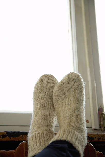 istock legs in warm knitted sockes 625953446