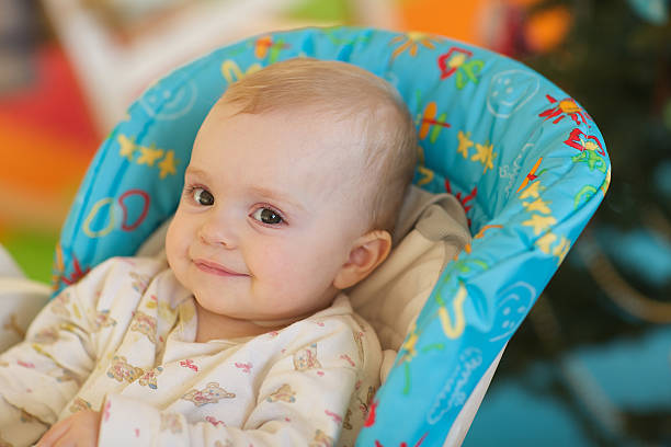 istock Baby in a feeding seat 625955450