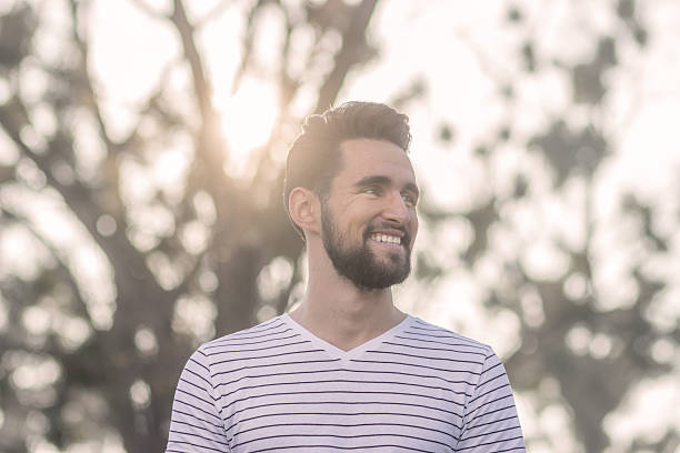 istock Smiling young adult man, looking sideways, head face. 625956172