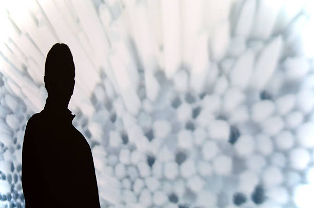 istock Silhouette of a man against floral pattern 625958900