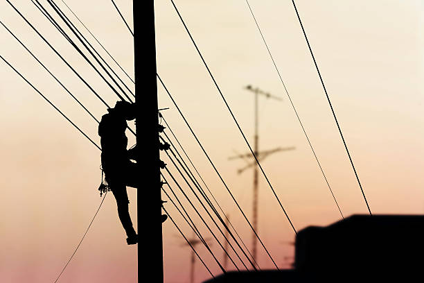 istock electrician working on electric power pole 625963094