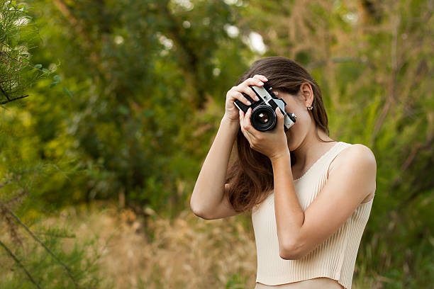 istock Young girl with retro photo camera 625963396