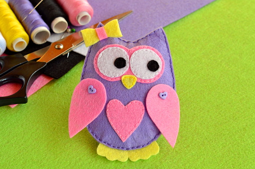Scissors, thread, felt sheets, needle, sewing kit. Cute felt owl