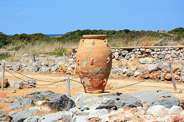 Knossos, Crete, Greece - June 25, 2025: Visitors examine well-preserved pottery from the Minoan civilization at Knossos, Crete.