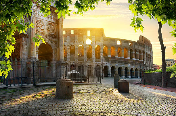 Colosseum and Arch Road to Colosseum in calm sunny morning costantino stock pictures, royalty-free photos & images