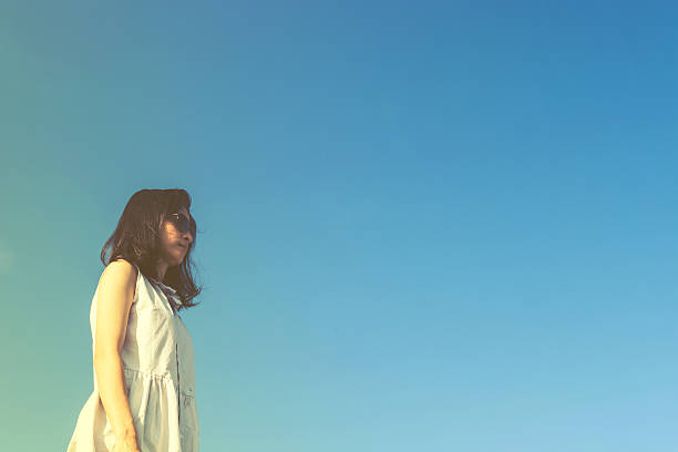 istock pretty asian girl relax with blue sky 625977670
