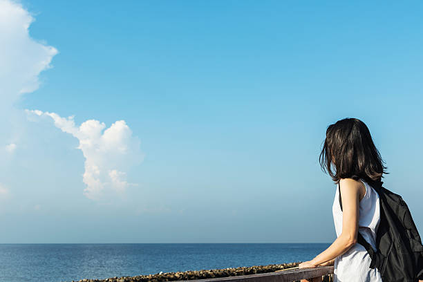 istock pretty asian girl relax with blue sky 625977706