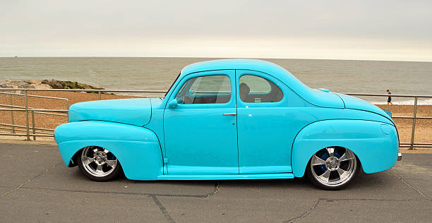 Classic Light Blue Hot rod  on seafront promenade. Felixstowe, Suffolk, England - August 27, 2016: Classic Light Blue Hot rod  on seafront promenade. cruising hot rods stock pictures, royalty-free photos & images
