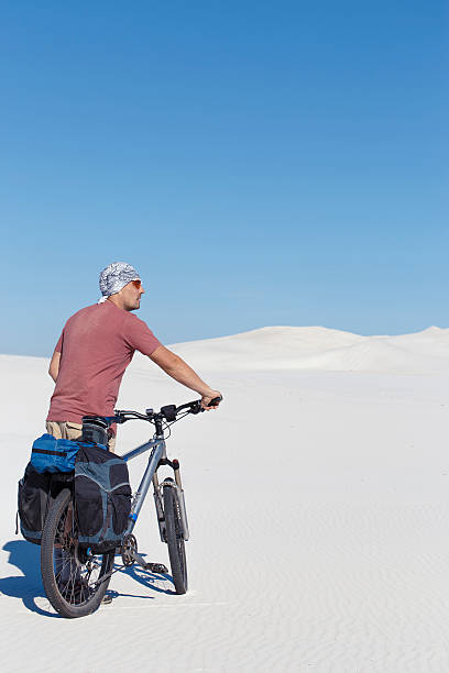 istock Traveling man on a bicycle in the desert. 625987932