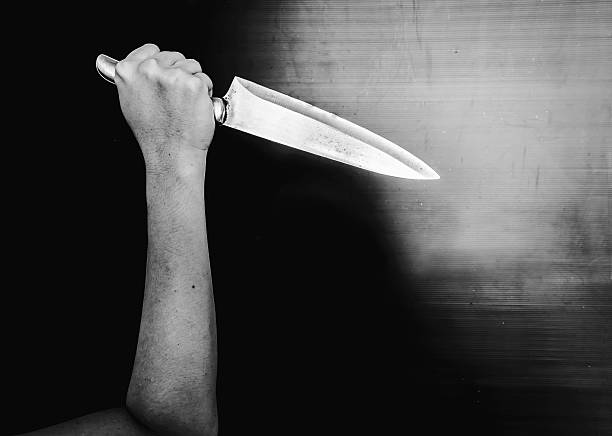 istock Arm Holding Knife in the Shadows 625987972