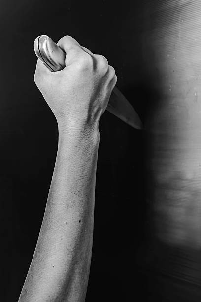 istock Arm Holding Knife in the Shadows 625987992