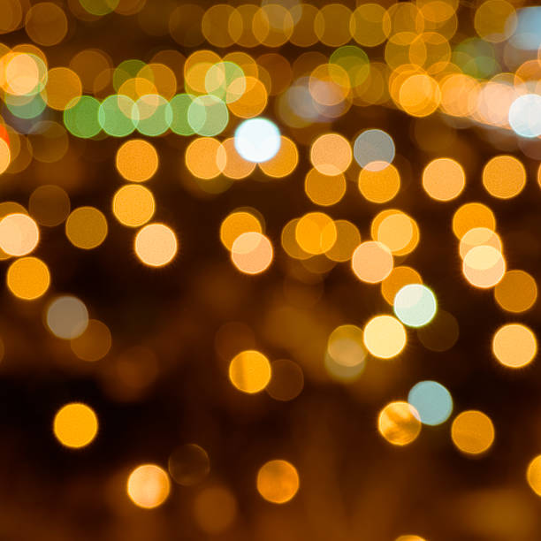 istock abstract festive background with bright golden lights, close up 625990782