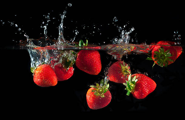 istock Strawberries splashing into water 625999710