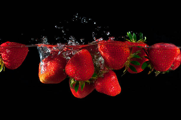 istock Strawberries splashing into water 625999754
