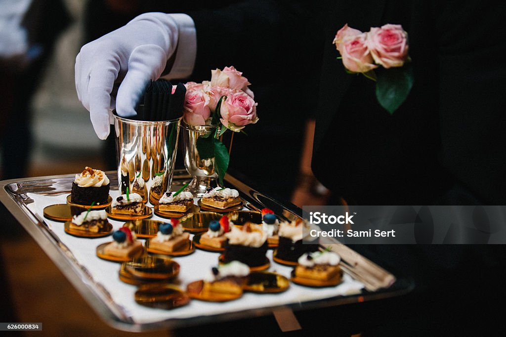 Luxury Delicious Appetizer Serving Professional caterer with white glove serve finger dessert foods during a cocktail wedding parties or events catering. Luxury Stock Photo