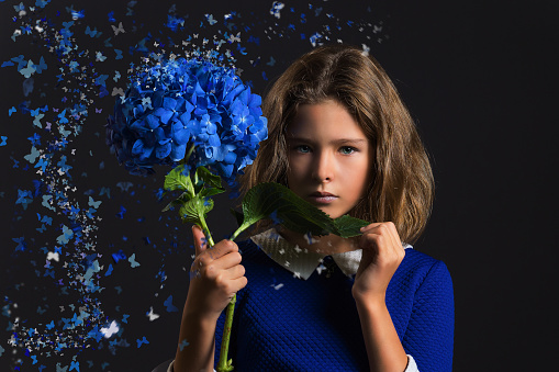 The girl with the blue hydrangea in the hands