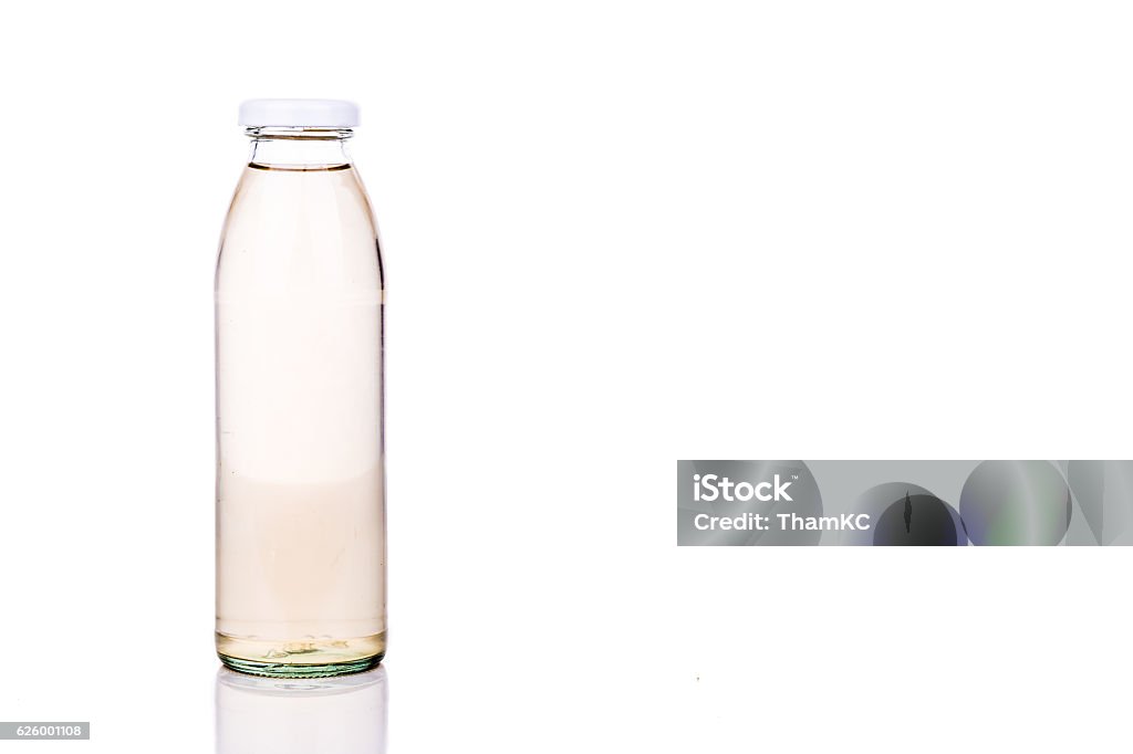 Three translucent liquid in glass bottle on white background Three translucent liquid in transparent glass bottle on white background Bottle Stock Photo