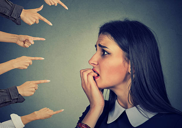 istock Anxious woman judged by different hands. Accusation concept 626003926