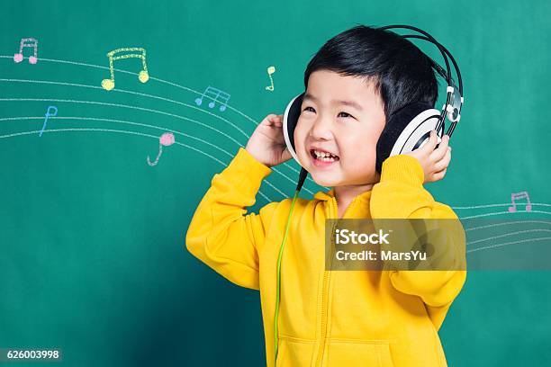 Boy Listening To Music Headphones Stock Photo - Download Image Now - Child, Music, Headphones