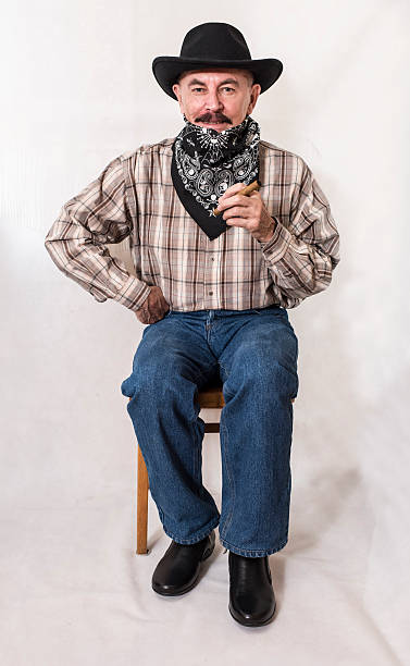 istock The cowboy with mustache,in a black hat smoking cigar 626005356