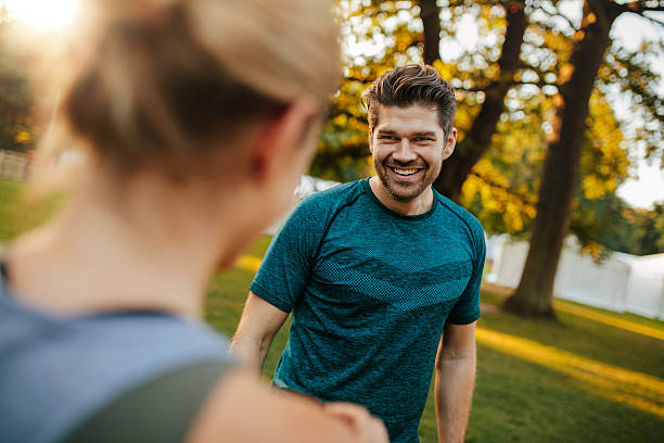 istock Fit young man smiling with woman in park 626006462