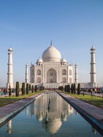 The Taj Mahal in Agra, India in all its splendor. Crowd of tourists is visible in the image.