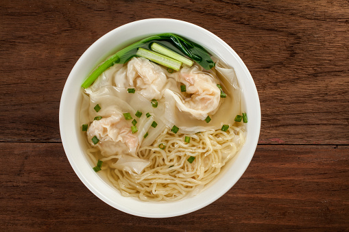 Chinese wonton noodle soup on a wood table