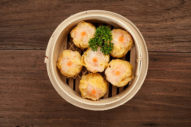 Chinese dim sum in a bamboo steamer box stock photo
