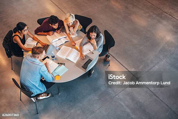 Group Of Students Studying On Laptop Stock Photo - Download Image Now - Studying, Group Of People, Student